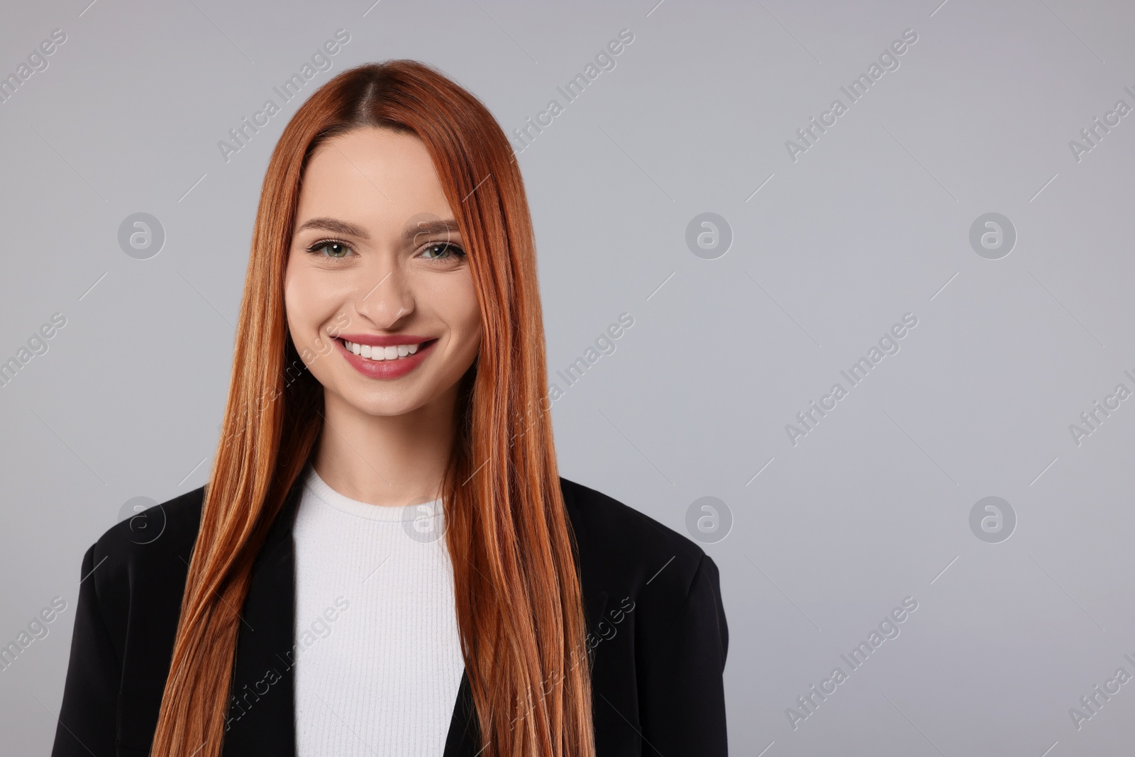 Photo of Portrait of beautiful young woman on light gray background, space for text