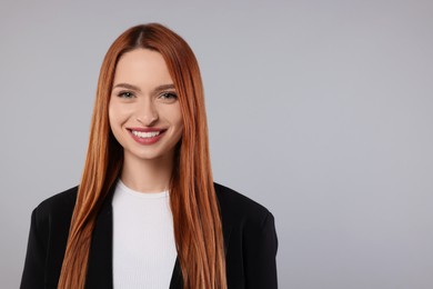 Photo of Portrait of beautiful young woman on light gray background, space for text