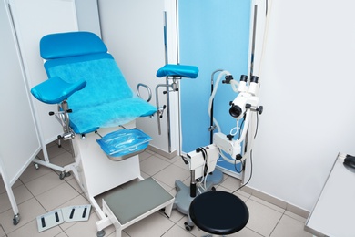 Gynecological clinic interior with chair and medical equipment