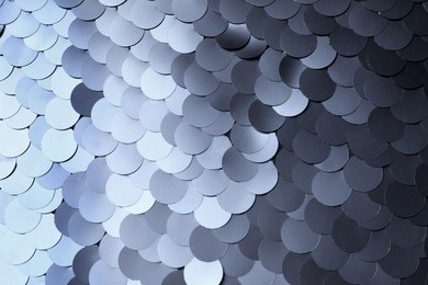 Texture of beautiful silver sequins as background, closeup