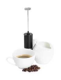 Photo of Mini mixer (milk frother), cup, coffee beans and pitcher isolated on white