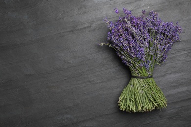 Photo of Beautiful lavender bouquet on black background, top view. Space for text