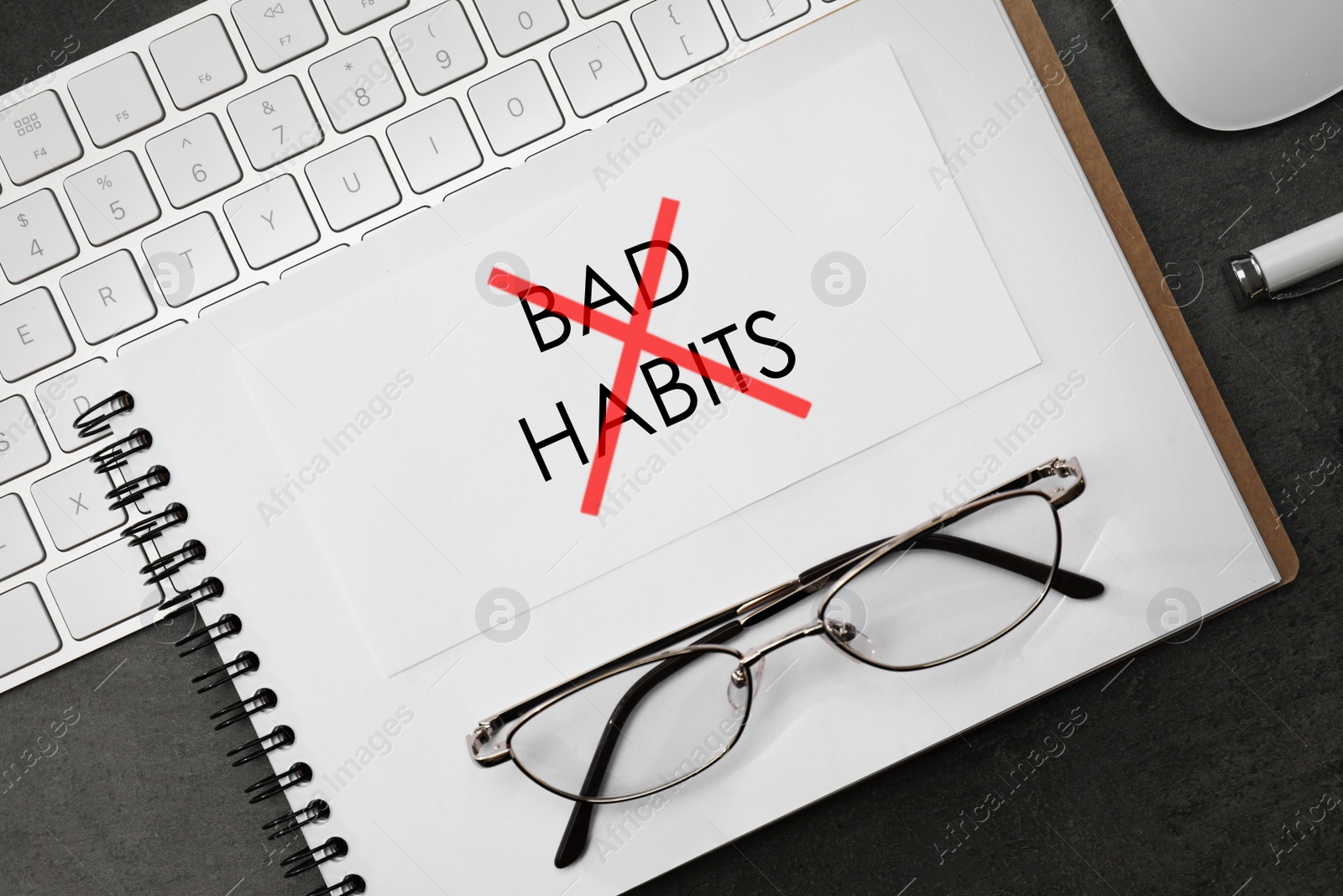 Image of Break bad habits. Text crossed with red lines in notebook, eyeglasses and computer keyboard on black table, flat lay