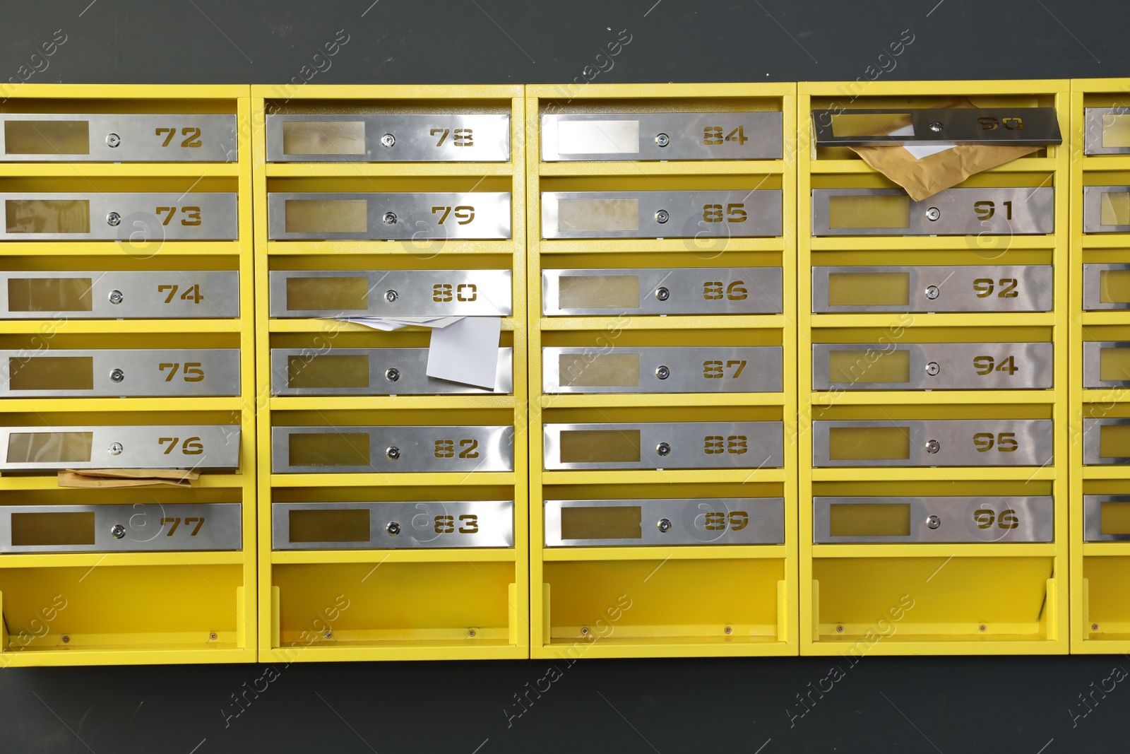 Photo of Metal mailboxes with keyholes, numbers and correspondence in post office