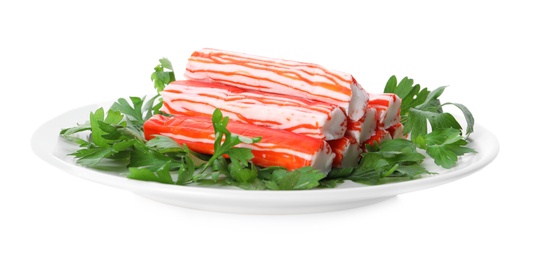 Photo of Plate with crab sticks and parsley on white background