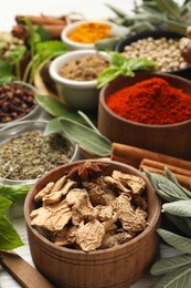 Photo of Different fresh herbs and spices on white wooden table, closeup