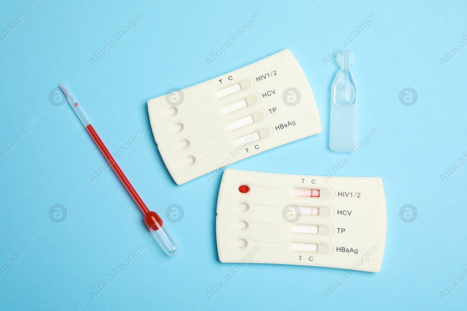 Photo of Disposable express hepatitis test kit on light blue background, flat lay