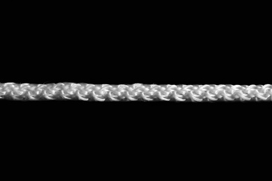 Photo of Strong straight white rope on black background