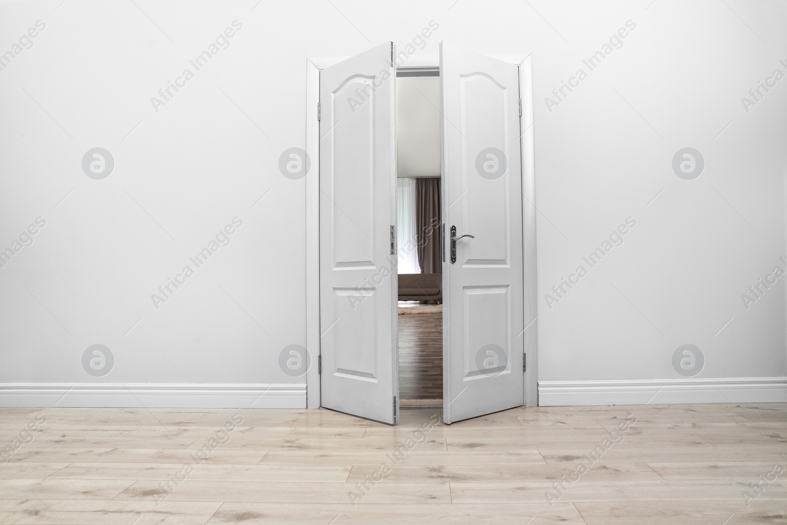 Photo of Stylish room interior, view through open door. Space for text