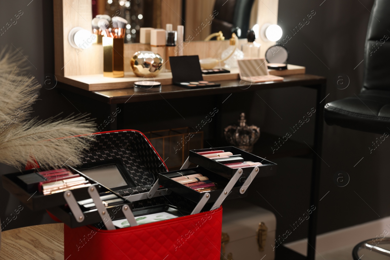 Photo of Beautician case with professional cosmetics in makeup room