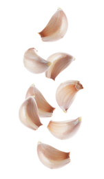 Image of Set of falling garlic cloves on white background