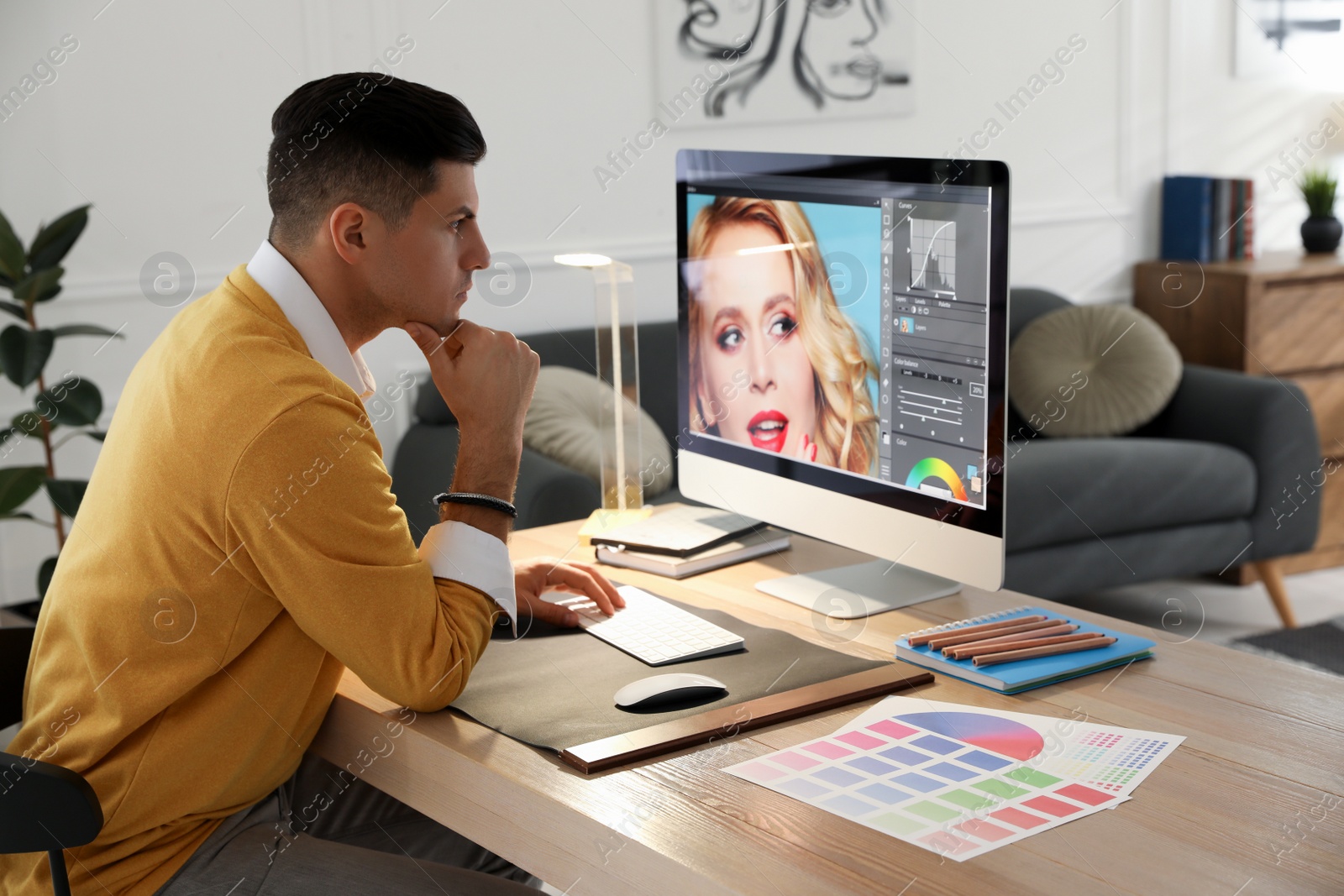 Photo of Professional retoucher working on computer in office