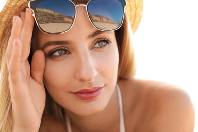 Beautiful woman wearing sunglasses outdoors on sunny day, closeup