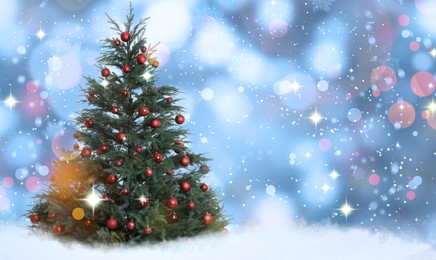 Image of Beautifully decorated Christmas tree on light blue background, space for text. Bokeh effect