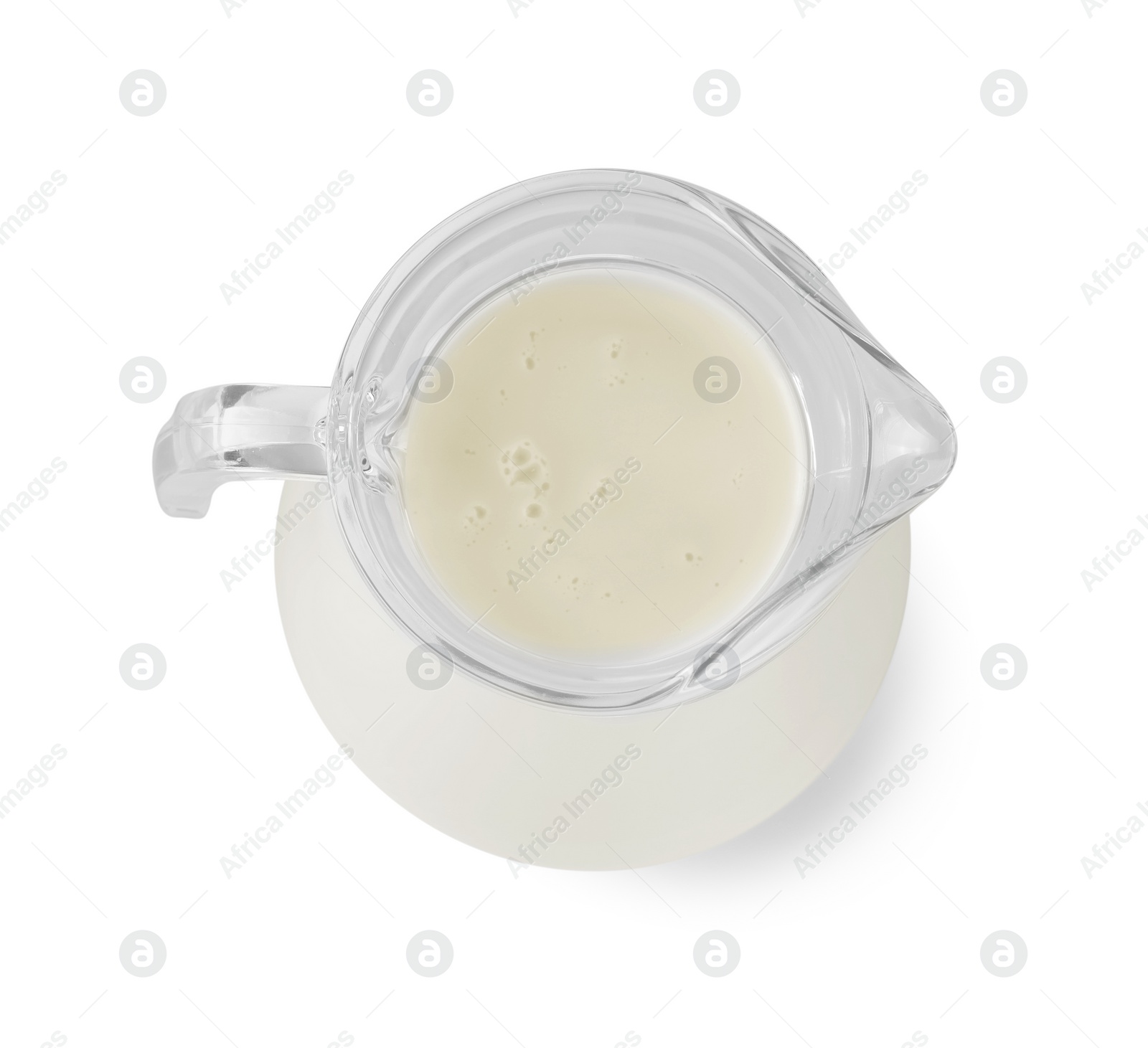 Photo of Glass jug of fresh milk isolated on white, top view