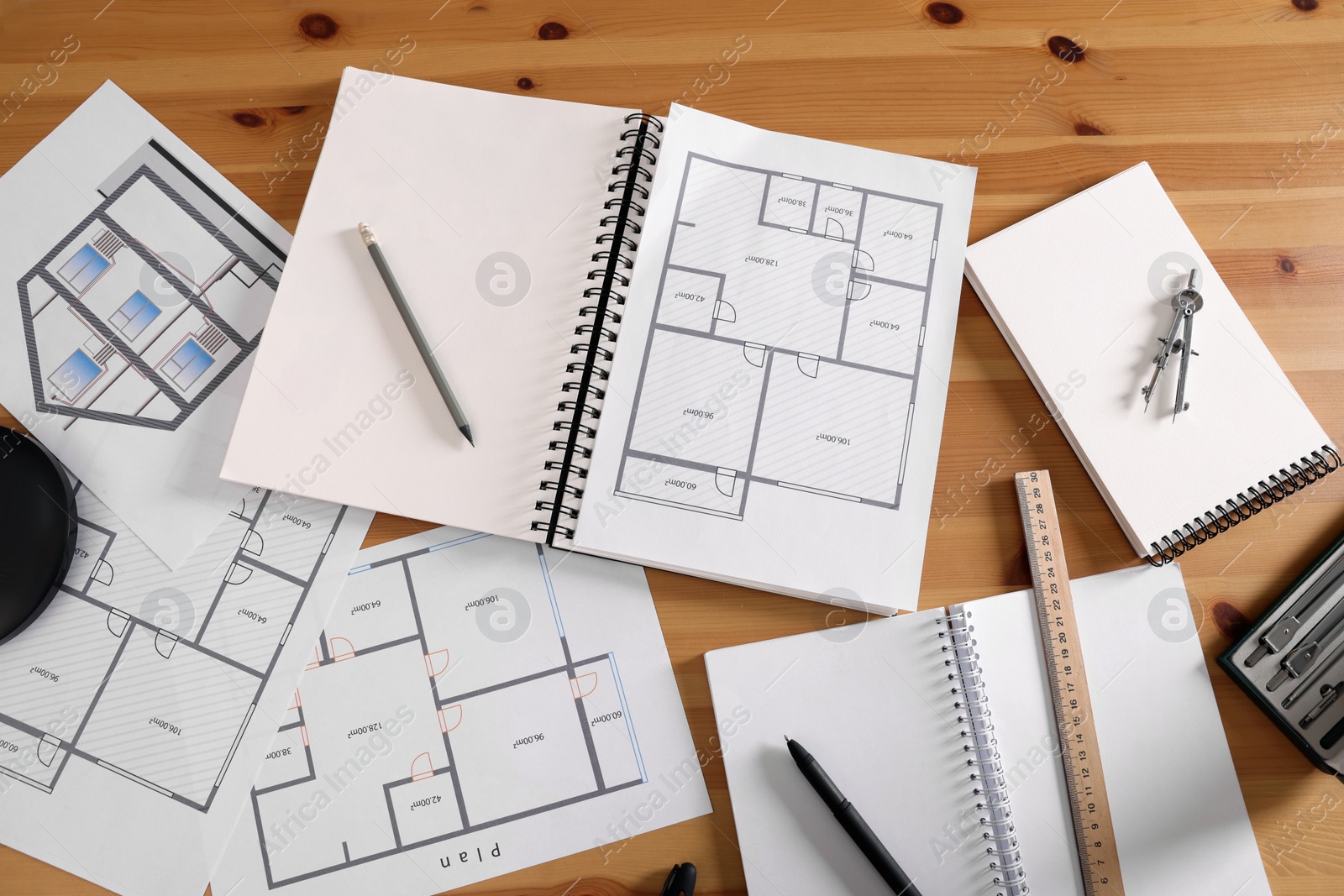 Photo of Sketchbook with construction drawings and pencil on wooden table, flat lay