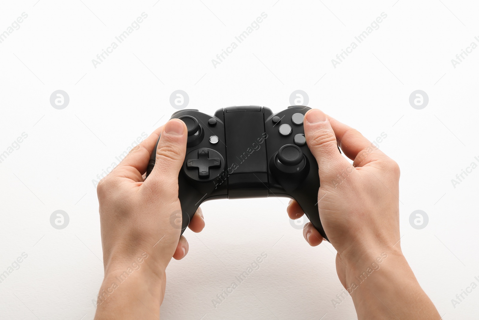 Photo of Young man holding video game controller on white background, closeup