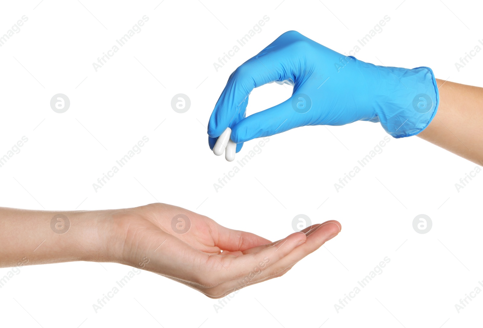 Photo of Doctor in medical glove giving pills to patient on white background