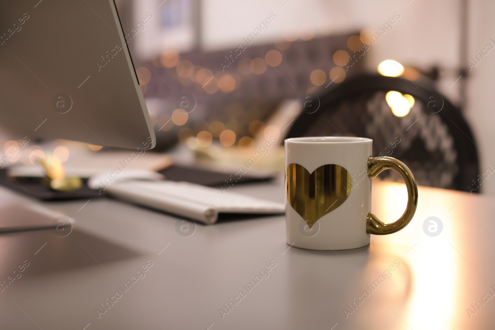 Photo of Stylish workplace with modern computer on desk. Focus on cup of drink