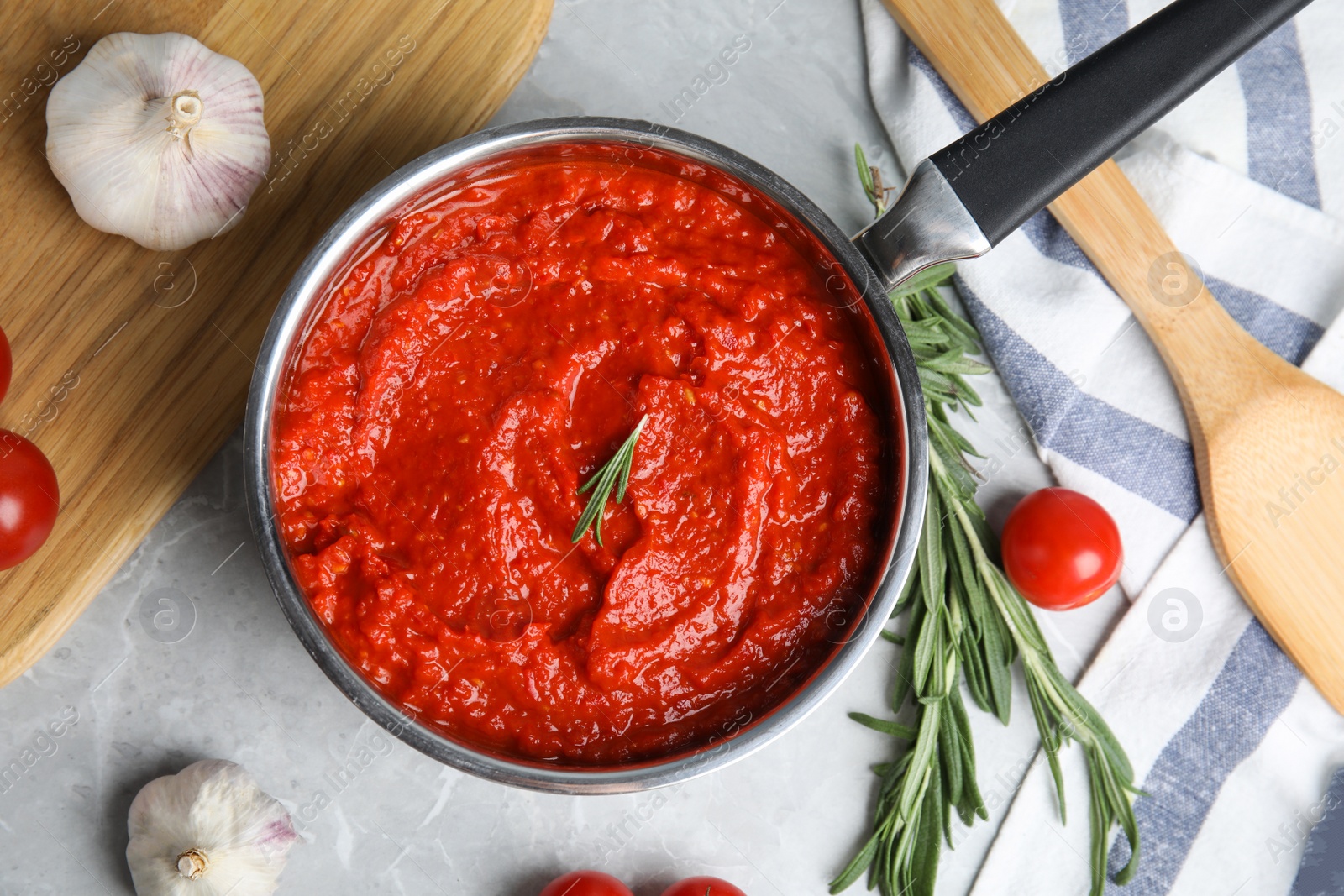 Photo of Flat lay composition with delicious tomato sauce on marble table