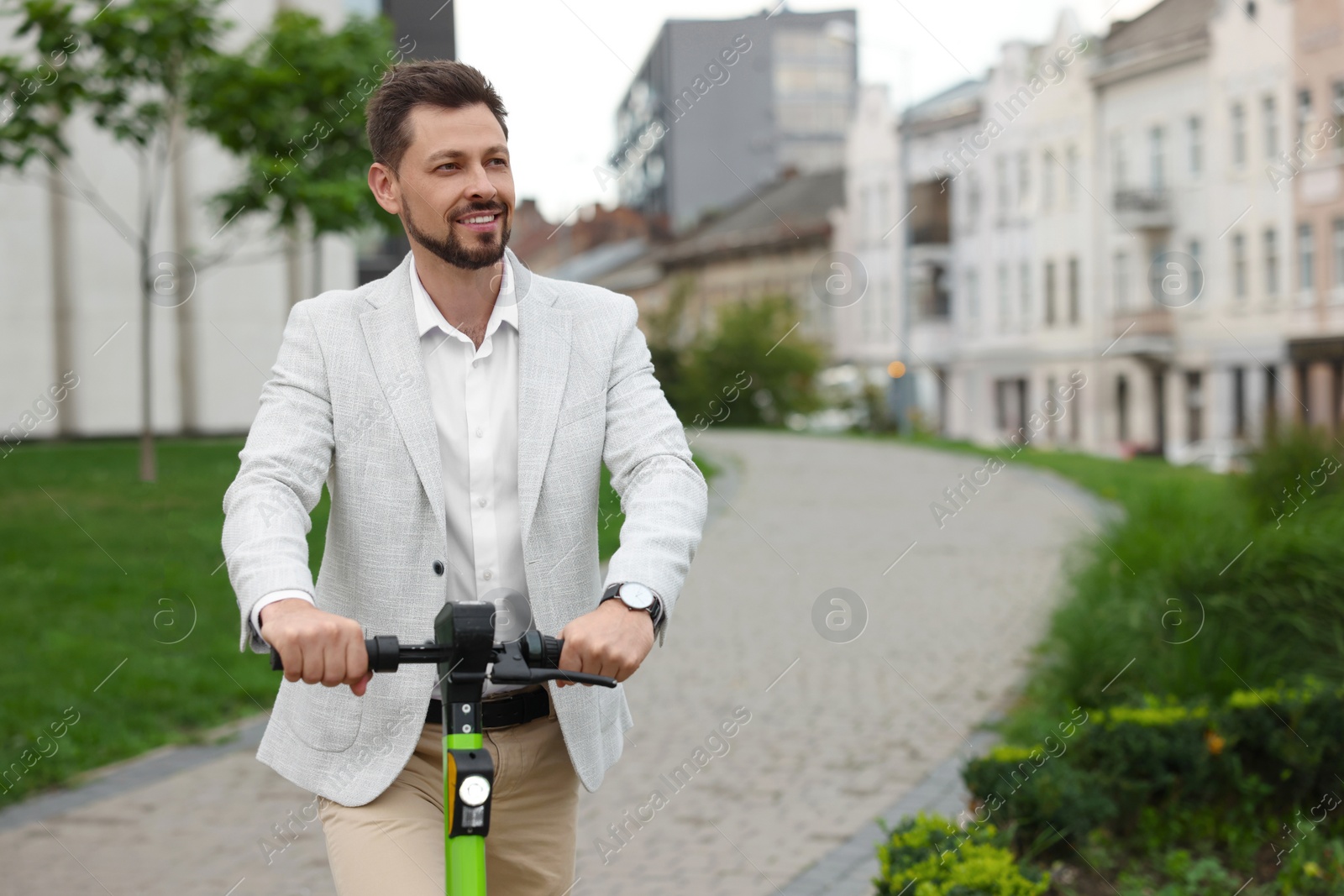 Photo of Businessman with modern kick scooter on city street, space for text