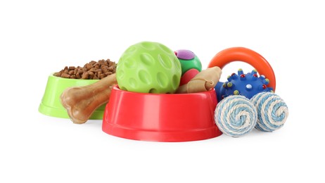 Various pet toys, food and bowl on white background