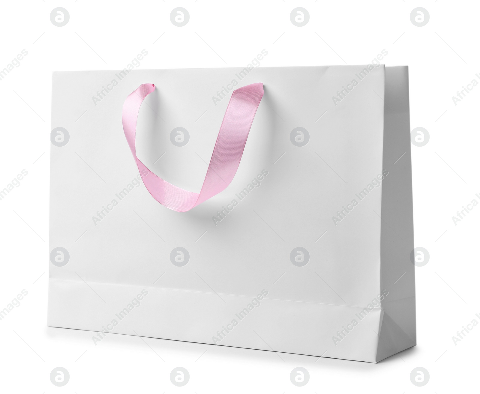 Photo of Paper shopping bag with ribbon handles on white background. Mockup for design