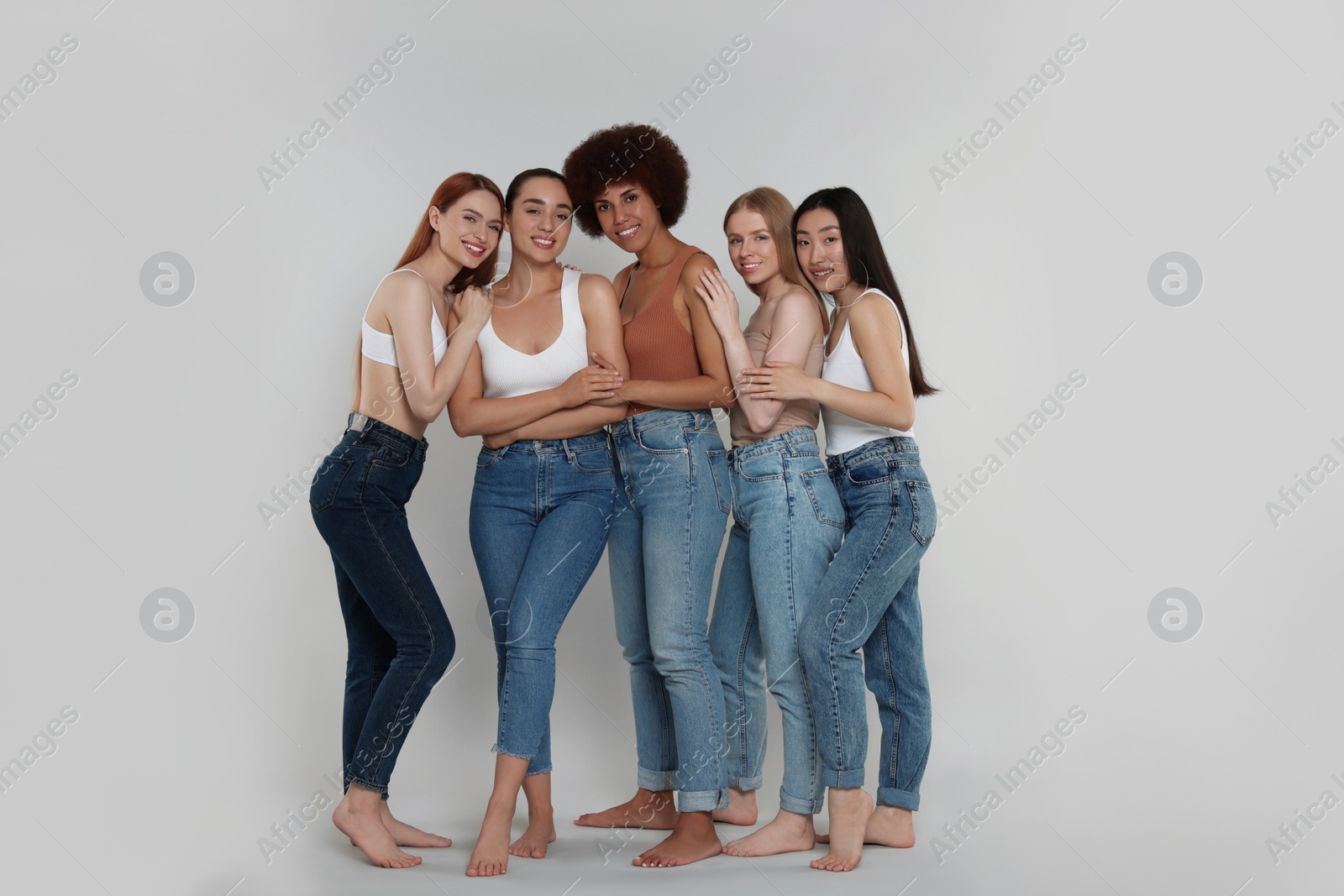 Photo of Group of beautiful young women on light grey background