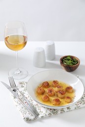 Photo of Delicious fried scallops served on white table