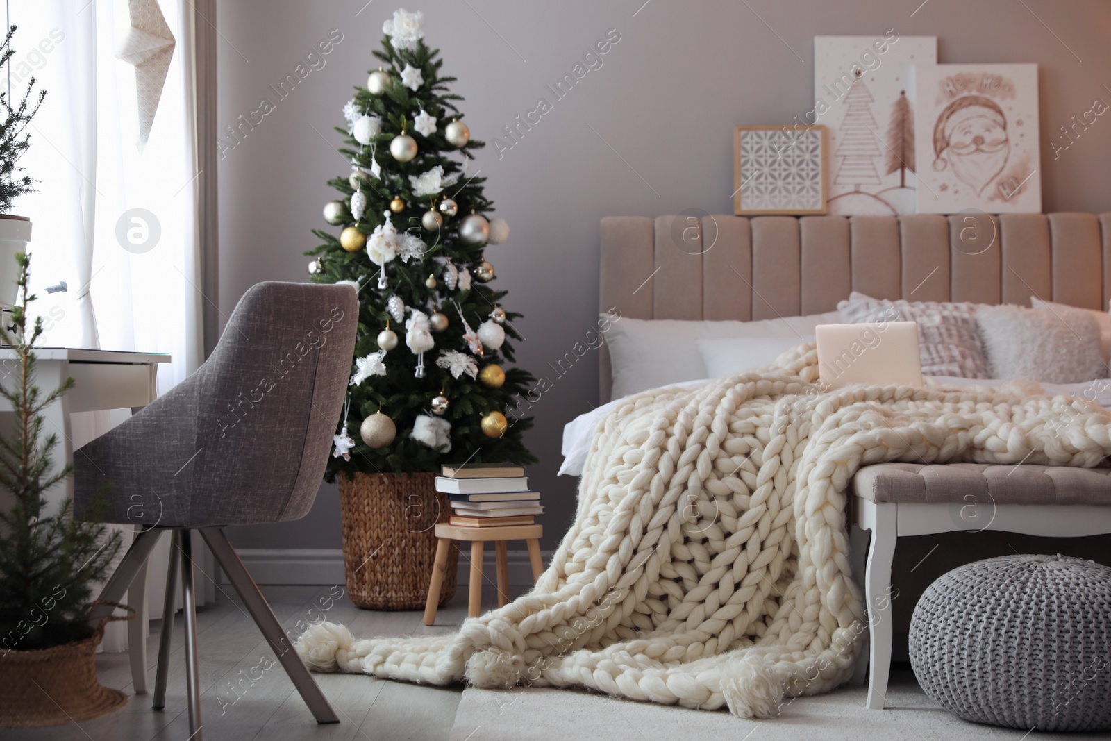 Photo of Beautiful decorated Christmas tree in bedroom interior