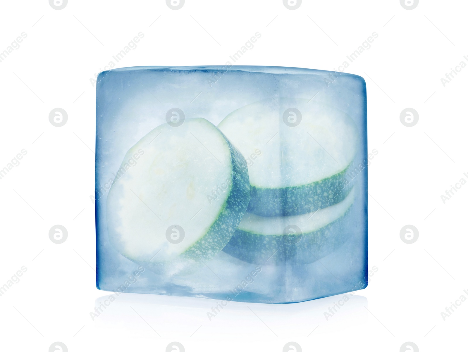 Image of Frozen food. Raw zucchini in ice cube isolated on white