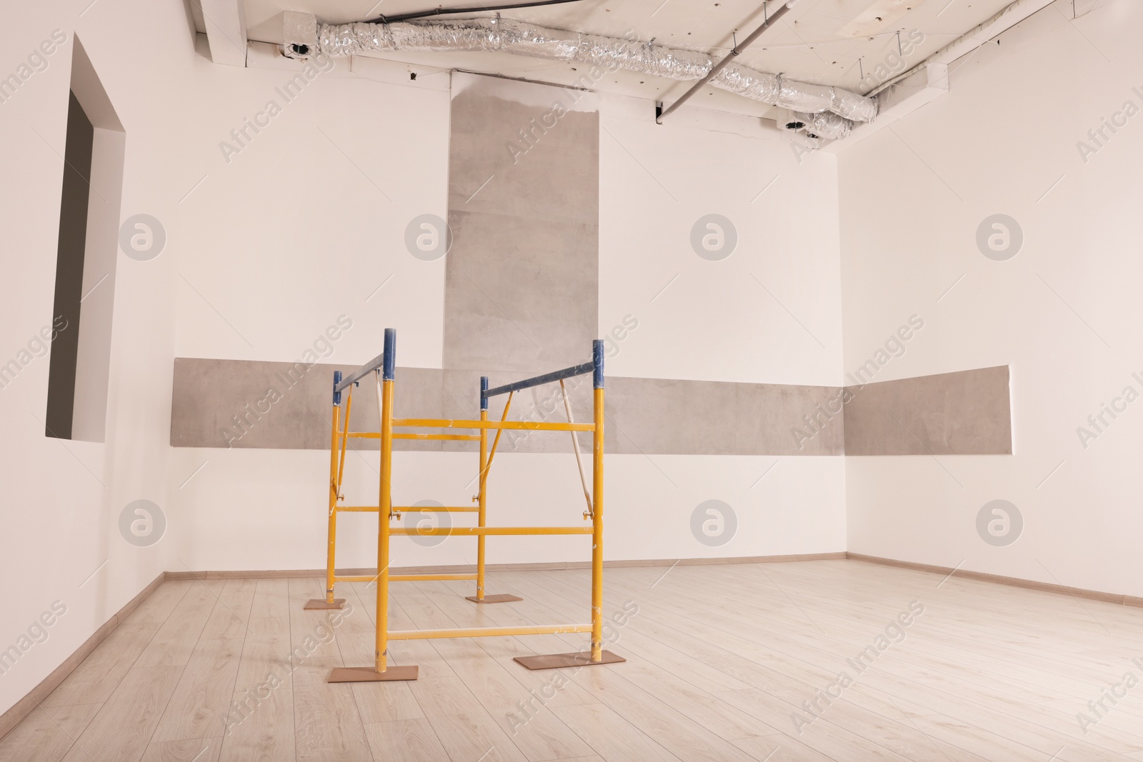 Photo of Professional construction scaffold in empty renovated room