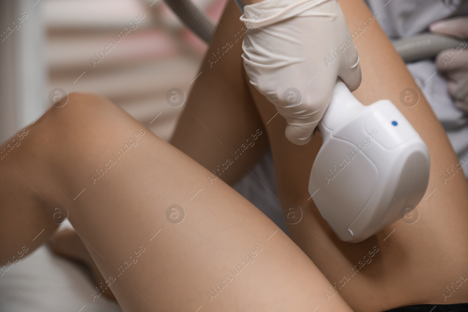 Photo of Woman undergoing laser epilation procedure in beauty salon, closeup