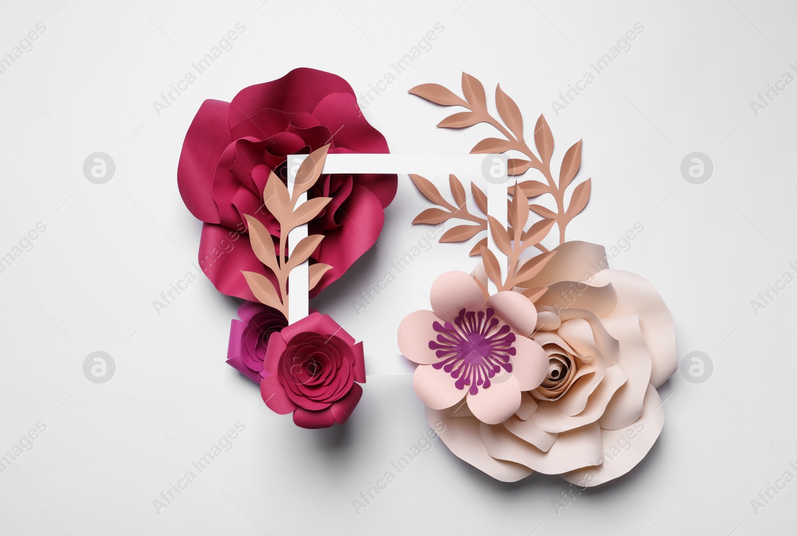 Photo of Different beautiful flowers made of paper and frame on light background, flat lay