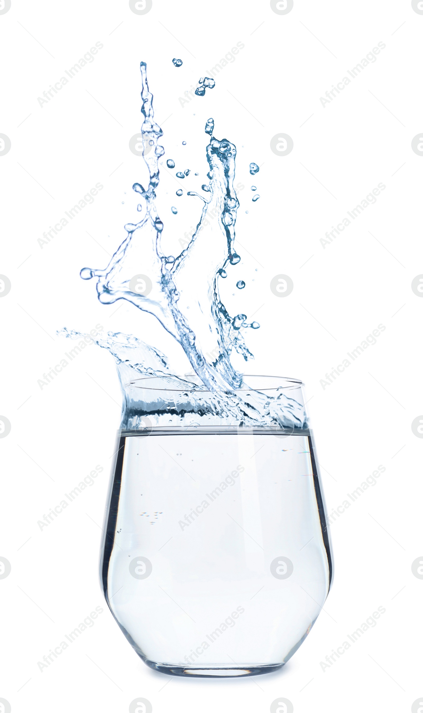 Image of Water splashing out of glass on white background. Refreshing drink