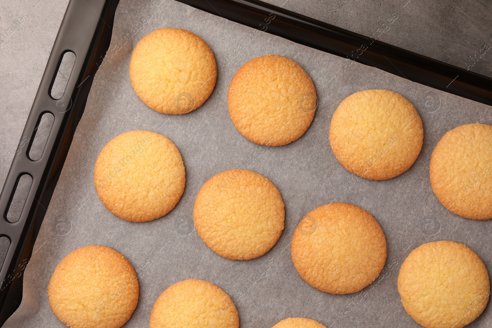 Photo of Delicious Danish butter cookies on baking tray, flat lay