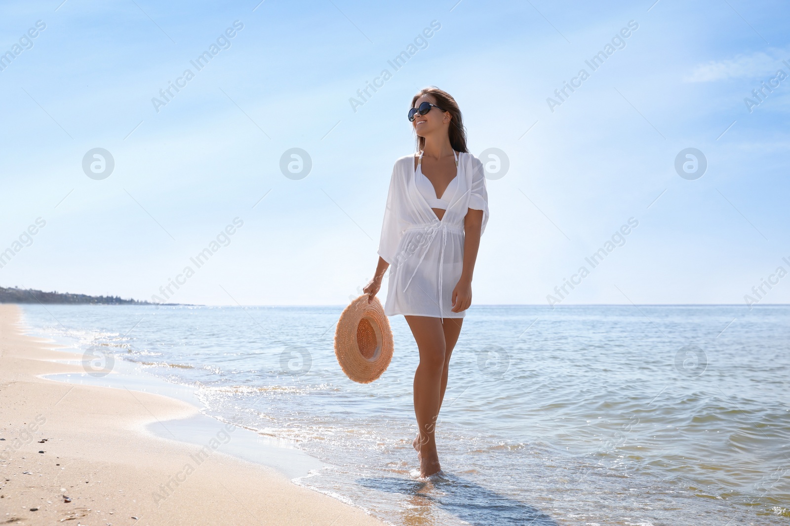 Photo of Young woman with beautiful body on sandy beach