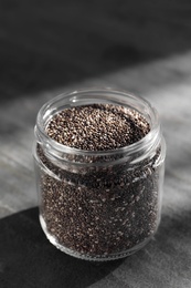 Glass jar with chia seeds on slate table