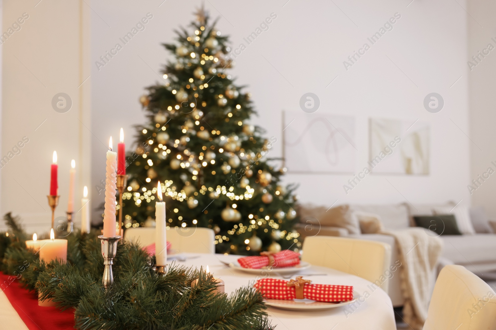 Photo of Festive table setting and beautiful Christmas decor in room. Interior design