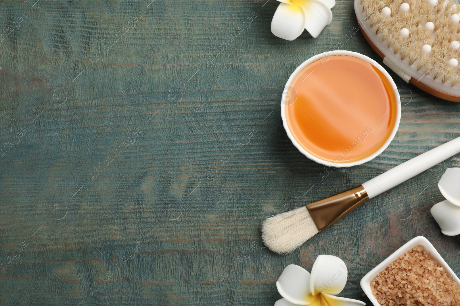 Photo of Flat lay composition with cosmetic product on light blue wooden background, space for text. Spa body wraps