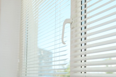 Photo of New modern window with blinds indoors. Home interior