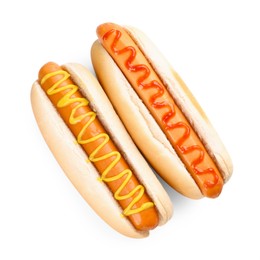 Photo of Tasty hot dogs with ketchup and mustard isolated on white, top view