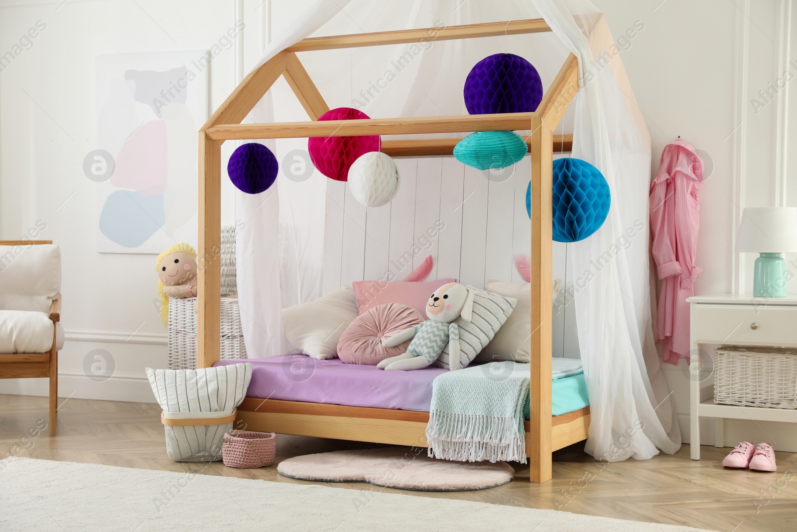 Photo of Stylish room for kid with house bed. Interior design