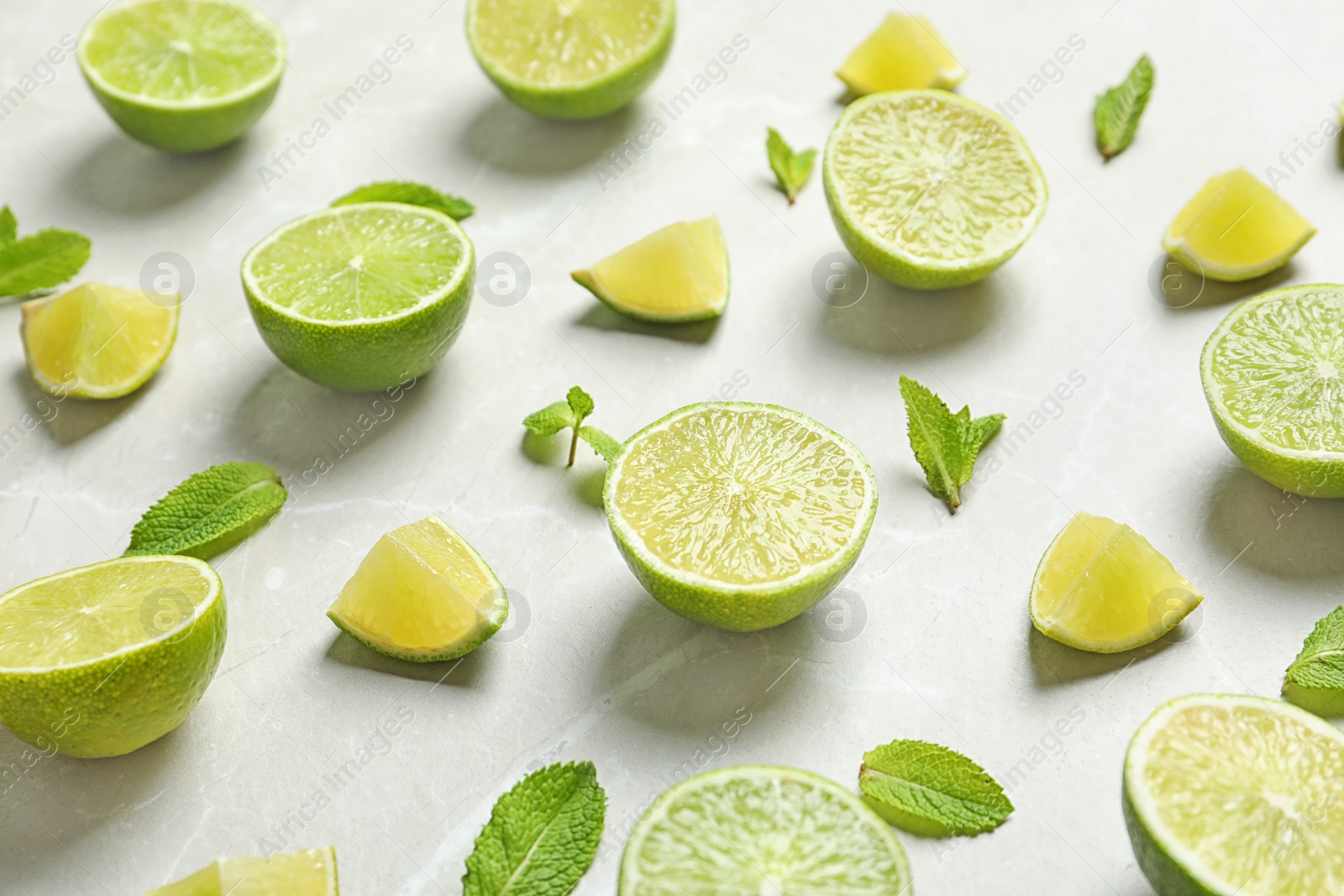 Photo of Composition with fresh ripe limes on light background