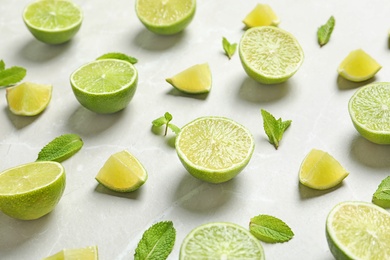 Composition with fresh ripe limes on light background