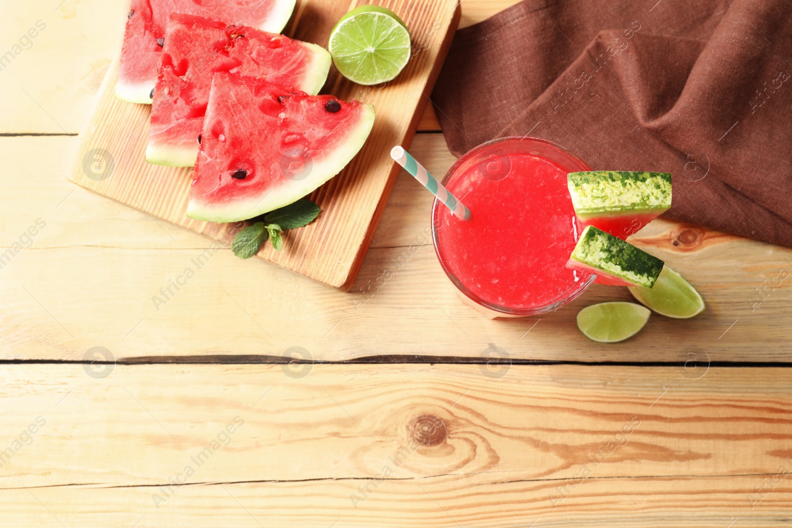 Photo of Summer watermelon drink in glass, sliced fruits and space for text on table, top view