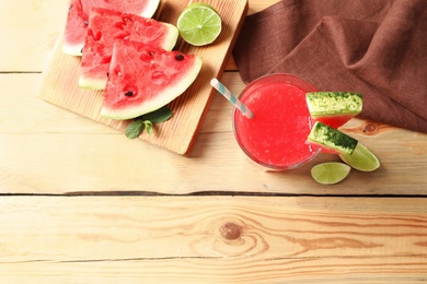 Photo of Summer watermelon drink in glass, sliced fruits and space for text on table, top view