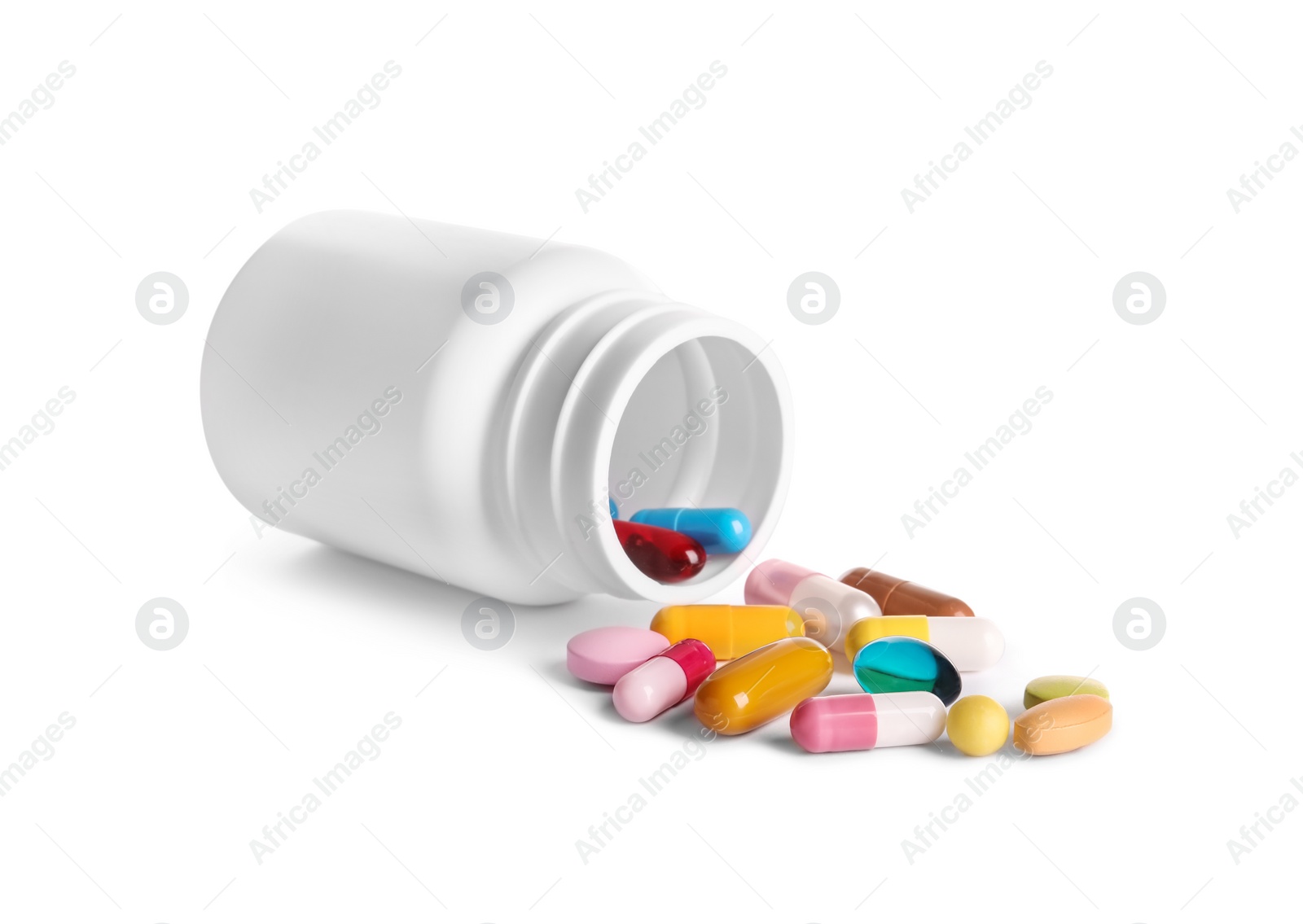 Photo of Plastic medical bottle with many different pills isolated on white