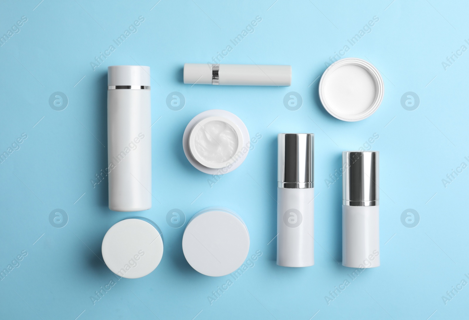 Photo of Set of luxury cosmetic products on light blue background, flat lay