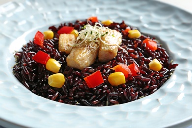 Photo of Boiled brown rice with meat in plate, closeup